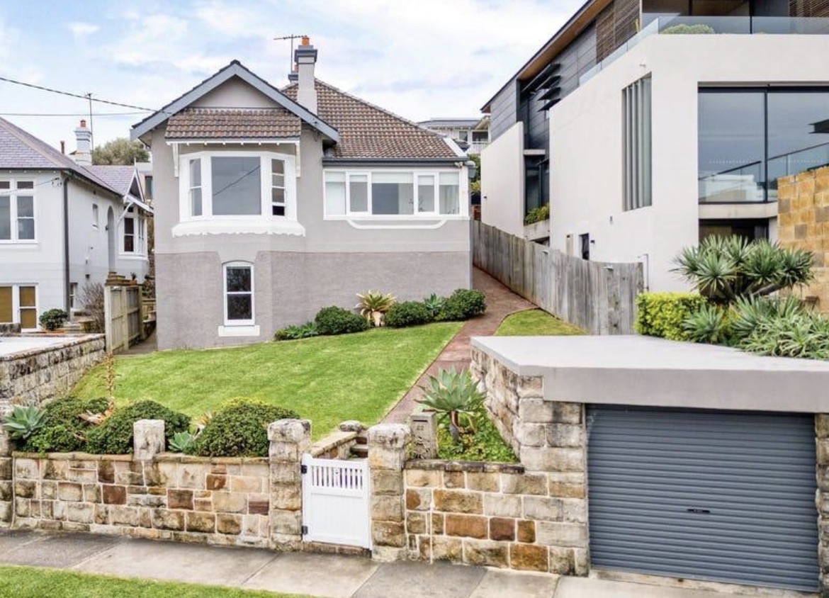 Trimmed front lawn and sandstone wall at a Federation home