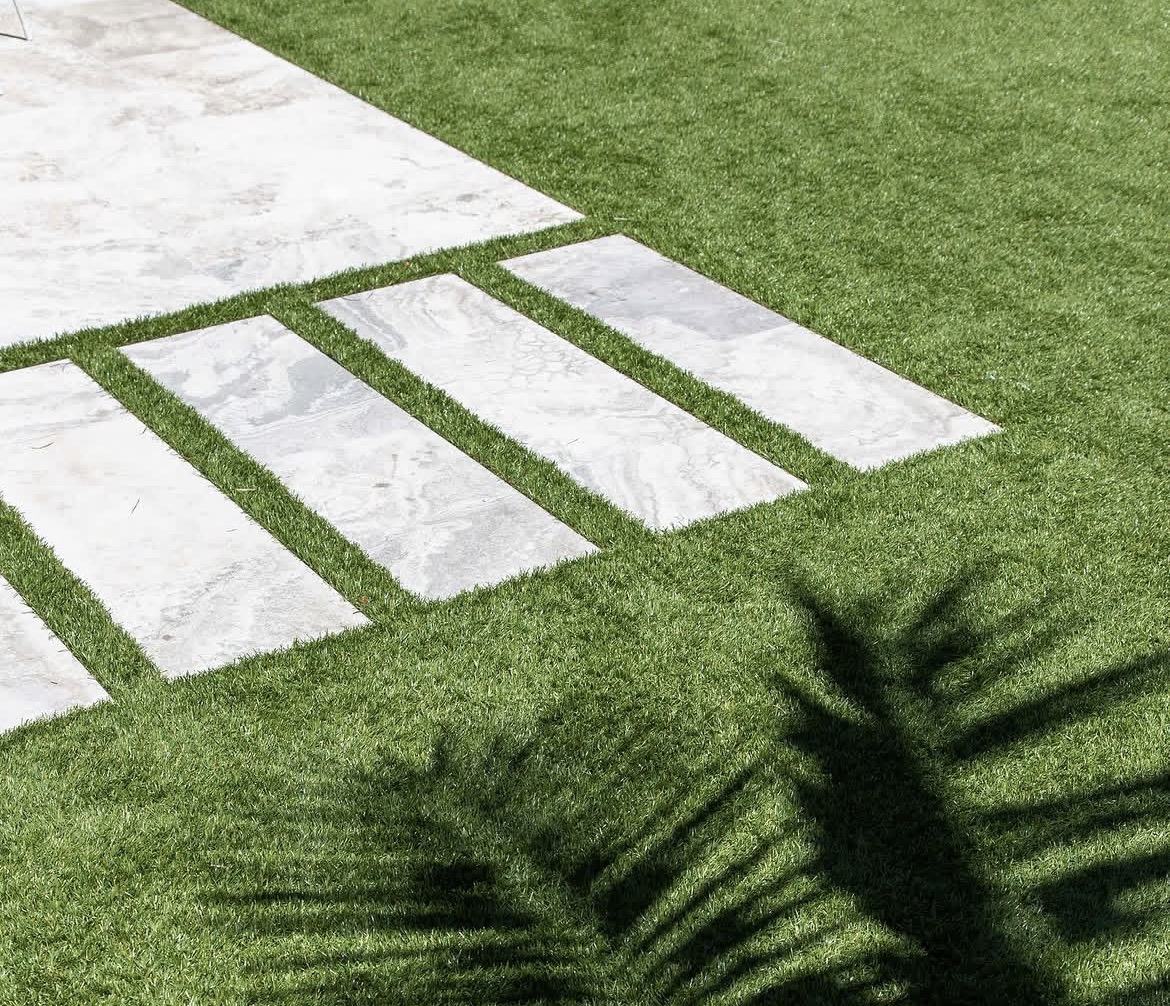 Freshly cut buffalo lawn with stone steppers in a Sydney garden